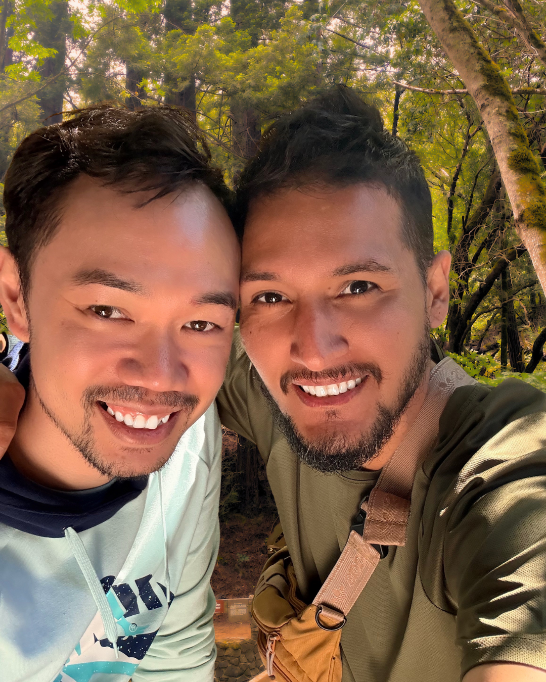 Two men taking a selfie in a forest setting